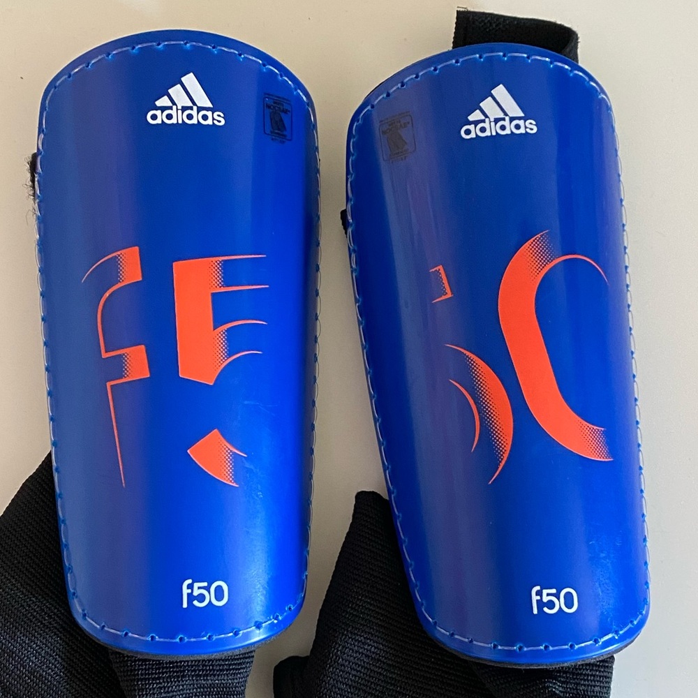 Adidas blue F50 soccer shin guards, youth large